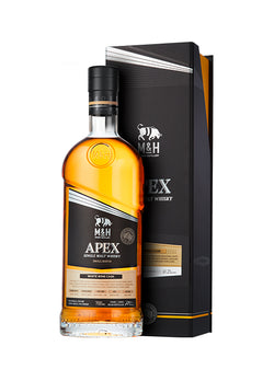 Eine Flasche M&H Apex Single Malt Whisky vor einer passenden schwarzen Verpackung.