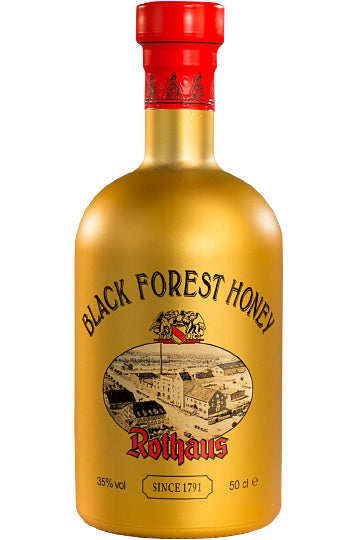 Eine goldene Flasche "Black Forest Honey" Likör der Marke Rothaus mit rotem Verschluss.