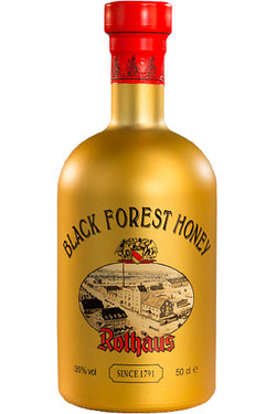 Eine goldene Flasche "Black Forest Honey" Likör der Marke Rothaus mit rotem Verschluss.